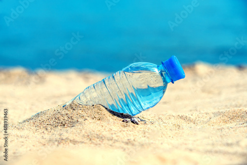 A bottle of drinking water on the sea beach 