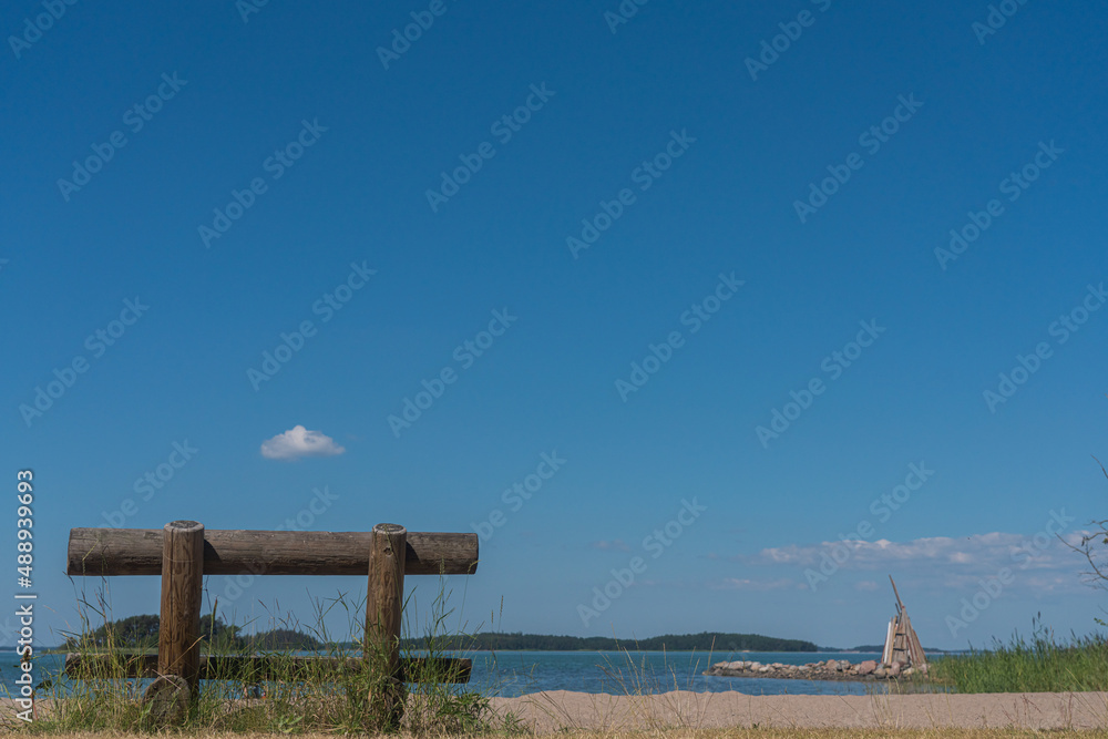 Wooden bench on the seashore, on a sunny summer day.Finland.