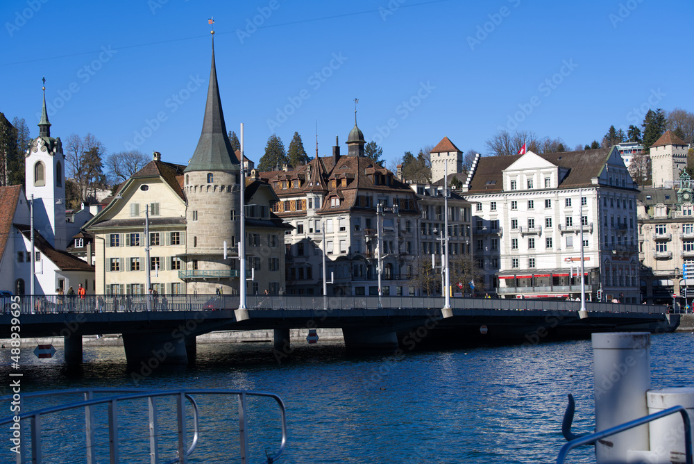 Cityscape of Luzern with Lake Bridge and lake Lucerne in the foreground on a sunny winter day. Photo taken February 9th, 2022, Lucerne, Switzerland.