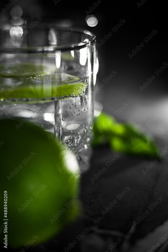 Close up view of a glass of crystal water with lime fruit slice Close up view of a glass of crystal water with lime fruit slice