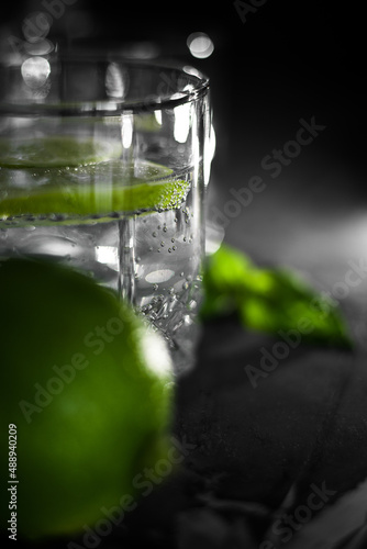 Close up view of a glass of crystal water with lime fruit slice