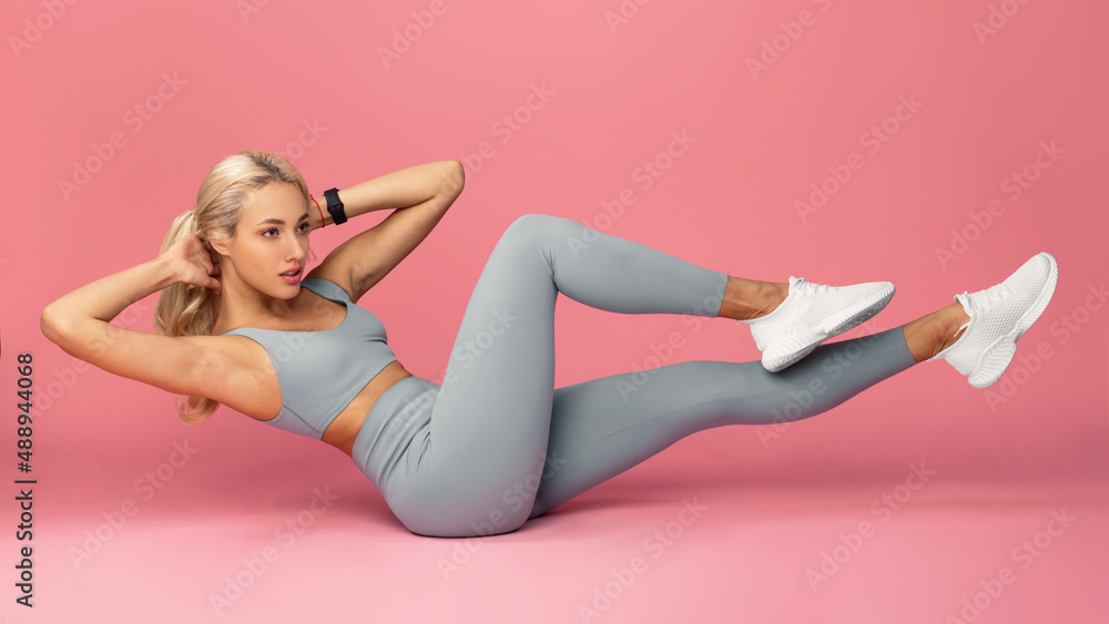 Young Woman Doing Abs Exercise, Side Crunches Young Woman Doing Abs Exercise, Side Crunches