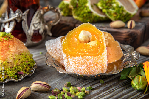 Oriental sweets. Lukum, pistachio baklava. Fragrant tea. Turkish mood still life. For advertising, window dressing, travel posters and cafes.