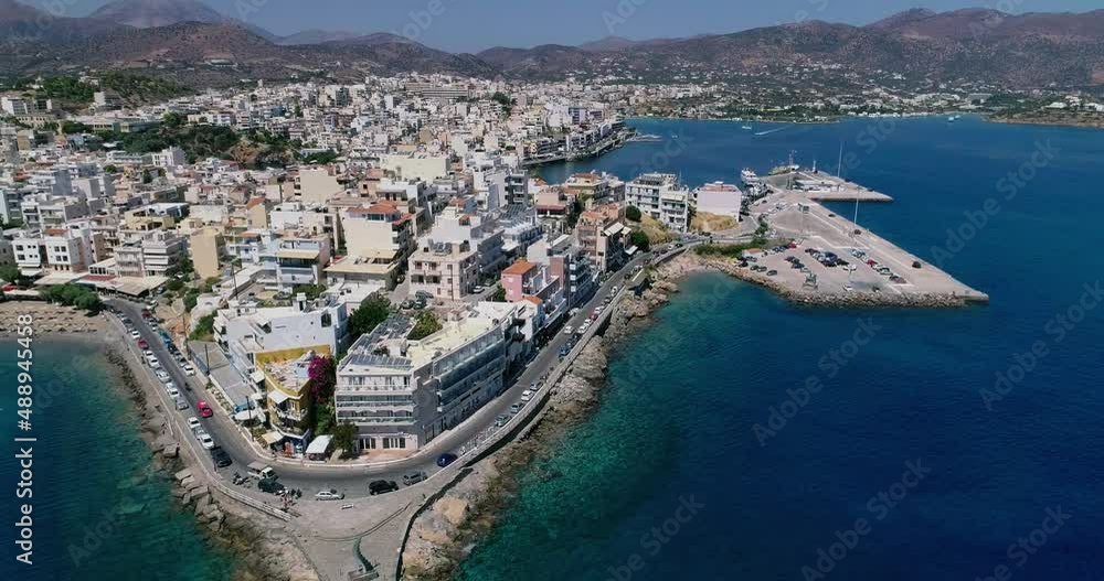 Drone shot over the marina, seaside boulevard, beaches, summer in Agios Nikolaos Crete Greece Drone shot over the marina, seaside boulevard, beaches, summer in Agios Nikolaos Crete Greece