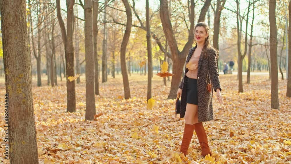 happy playful woman in coat, hat and scarf in autumn park happy playful woman in coat, hat and scarf in autumn park