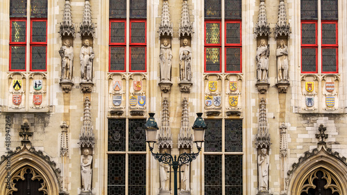 Architectural details of Bruges City Hall building in Burg square, Belgium photo