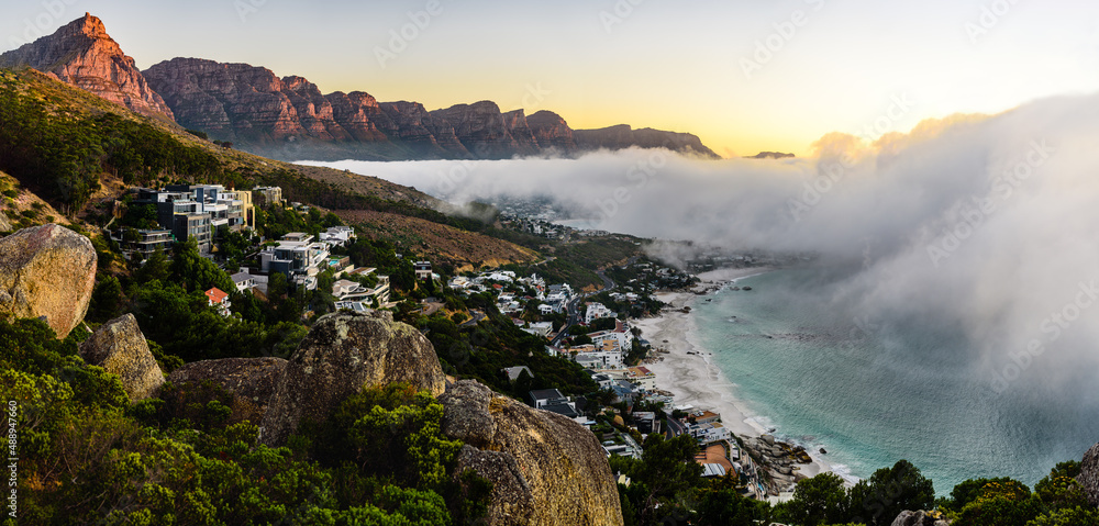A huge cloud over the Camps Bay in Cape Town during sunset.