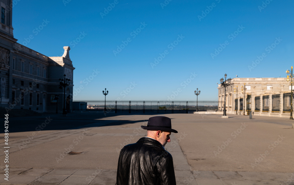 Adult man in hat and leather jacket on square. Madrid, Spain