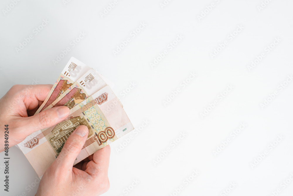 Hands holding money on white background, copy space. Top view male caucasian hands and cash rubles, close-up. Concept finance, poverty, poor Hands holding money on white background, copy space. Top view male caucasian hands and cash rubles, close-up. Concept finance, poverty, poor