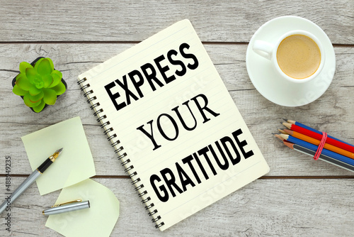express your gratitude. Open notepad with office supplies on a wooden table. colour pencils