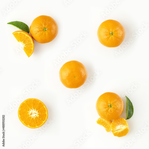Fresh ripe whole and sliced mandarin  tangerine or clementine isolated on white background