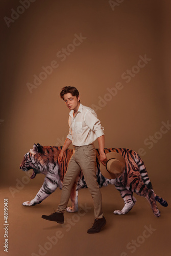 Beautiful man with tiger in studio