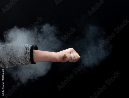 Fist on a black background  smoke