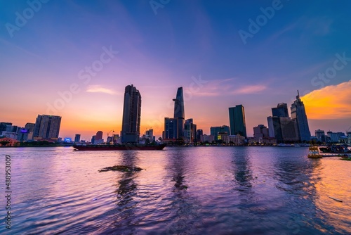 View of Bitexco Financial Tower building  buildings  roads  Thu Thiem bridge and Saigon river in Ho Chi Minh city in sunset.