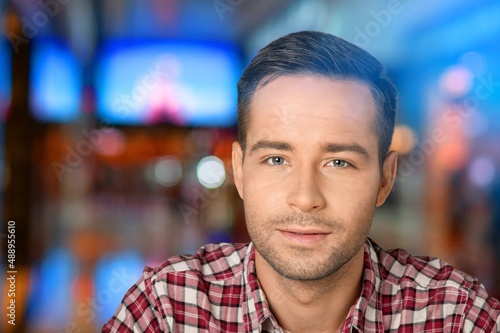 Portrait of Handsome Man Smiling, Looking at Camera, Standing in Night City with Bokeh