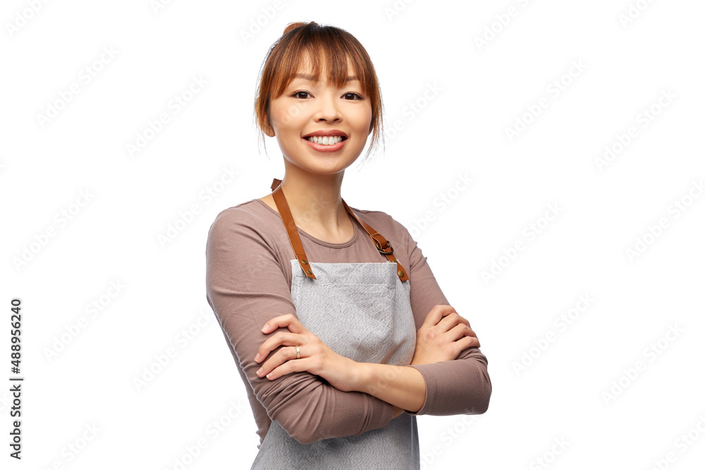 cooking, culinary and people concept - happy smiling female chef or waitress in apron with crossed arms over white background cooking, culinary and people concept - happy smiling female chef or waitress in apron with crossed arms over white background