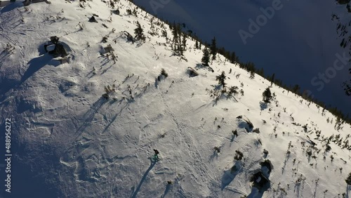 Aerial view of a skier climbing up the mountain. photo