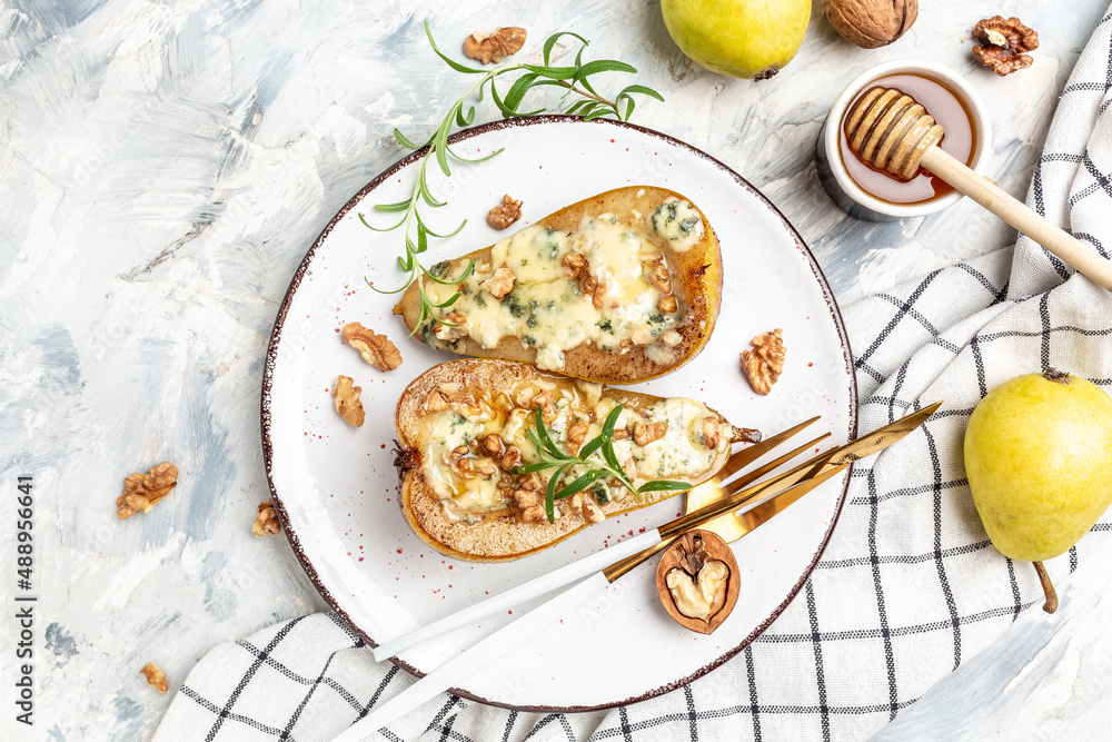 Pears baked with blue cheese, nuts and honey. French cuisine. Keto diet. Vegetarian lunch. banner, menu, recipe place for text, top view Pears baked with blue cheese, nuts and honey. French cuisine. Keto diet. Vegetarian lunch. banner, menu, recipe place for text, top view