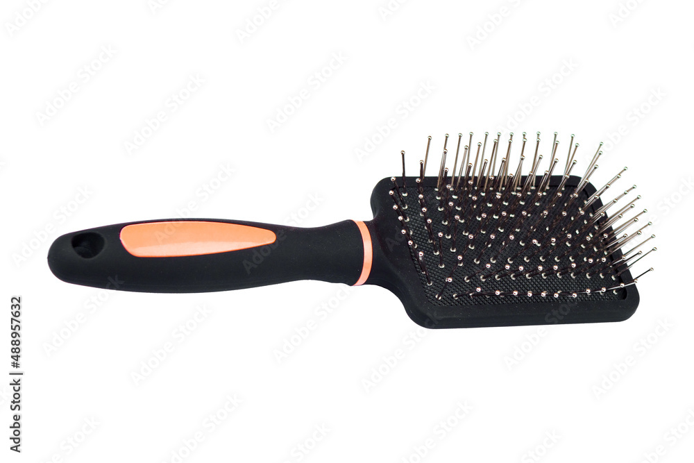 Massage comb for combing hair. Plastic brush with metal corners for detangling hair. On an isolated white background.close-up. Massage comb for combing hair. Plastic brush with metal corners for detangling hair. On an isolated white background.close-up.