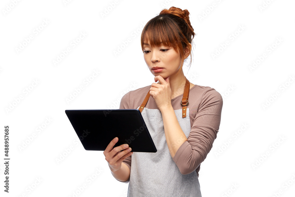 cooking, technology and people concept - happy smiling female chef or waitress in apron with tablet pc computer over white background