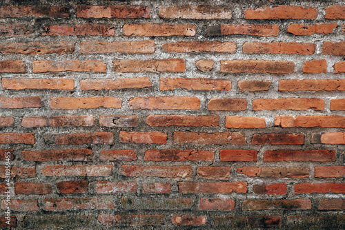 Old grunge dirty brick wall surface. Abstract tiled brick work background and pattern.