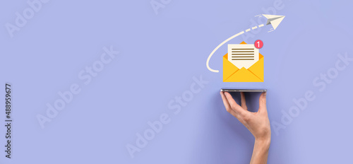 Businessman hand holding letter icon,email icons.Contact us by newsletter email and protect your personal information from spam mail.Customer service call center contact us.Email marketing newsletter. photo