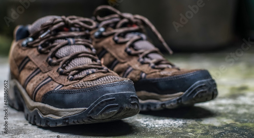 Hiking trekking shoes with blur background, selected focus