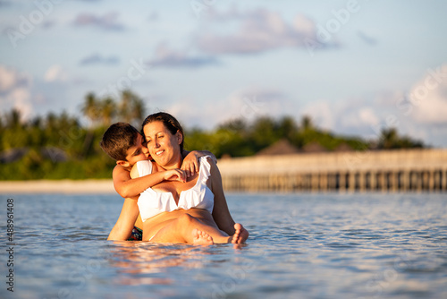 Son hugging his mother on the beach
