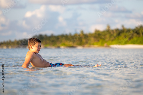 Fototapeta Naklejka Na Ścianę i Meble -  Relaxed boy lying on water of the Indian ocean
