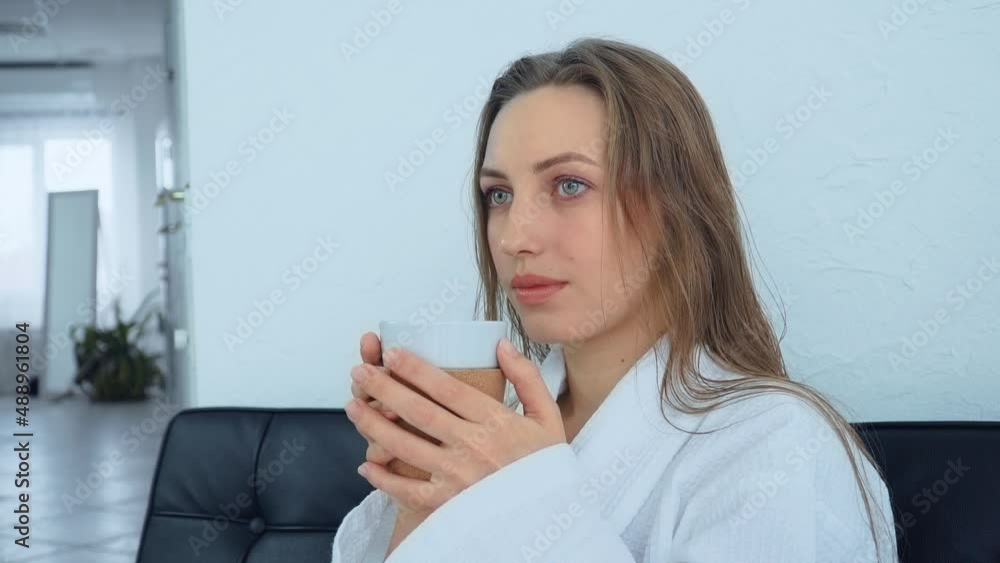 No makeup young woman sipping herbal tea in beauty salon. Female with white cup. Concept of body care and rehabilitation of spiritual peace No makeup young woman sipping herbal tea in beauty salon. Female with white cup. Concept of body care and rehabilitation of spiritual peace