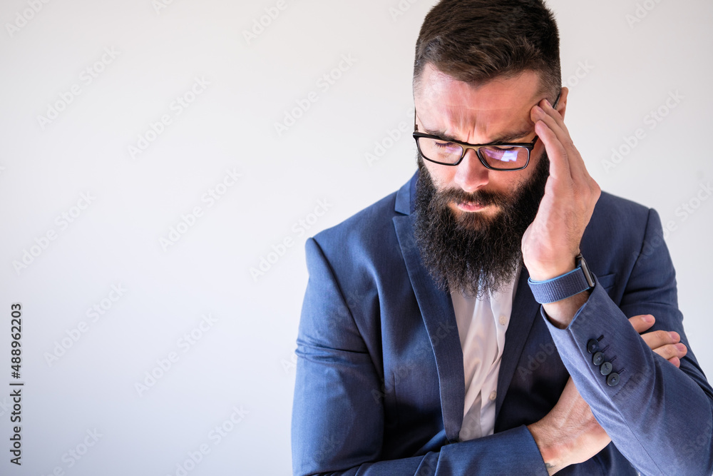 Portrait of businessman who is having headache. Copy space on image for your text or advert. Portrait of businessman who is having headache. Copy space on image for your text or advert.