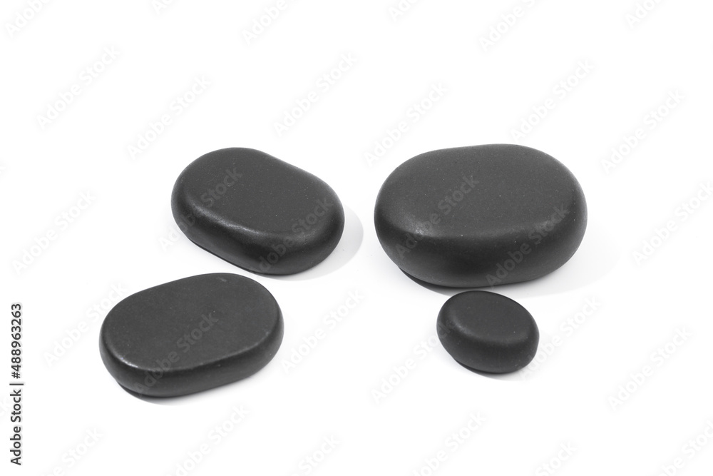 black spa stones isolated on white background . black spa stones isolated on white background .