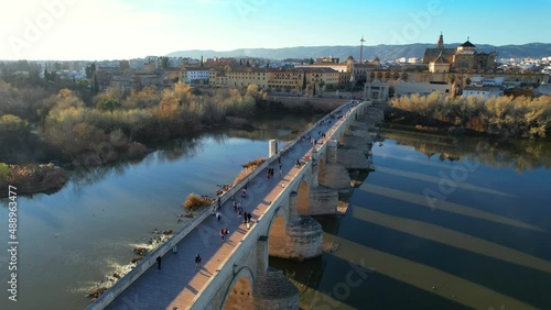 town of Cordoba in Andalusia, Spain, flying above medieval cathedral and roman bridge over Guadalquivir river, UNESCO World Heritage site photo