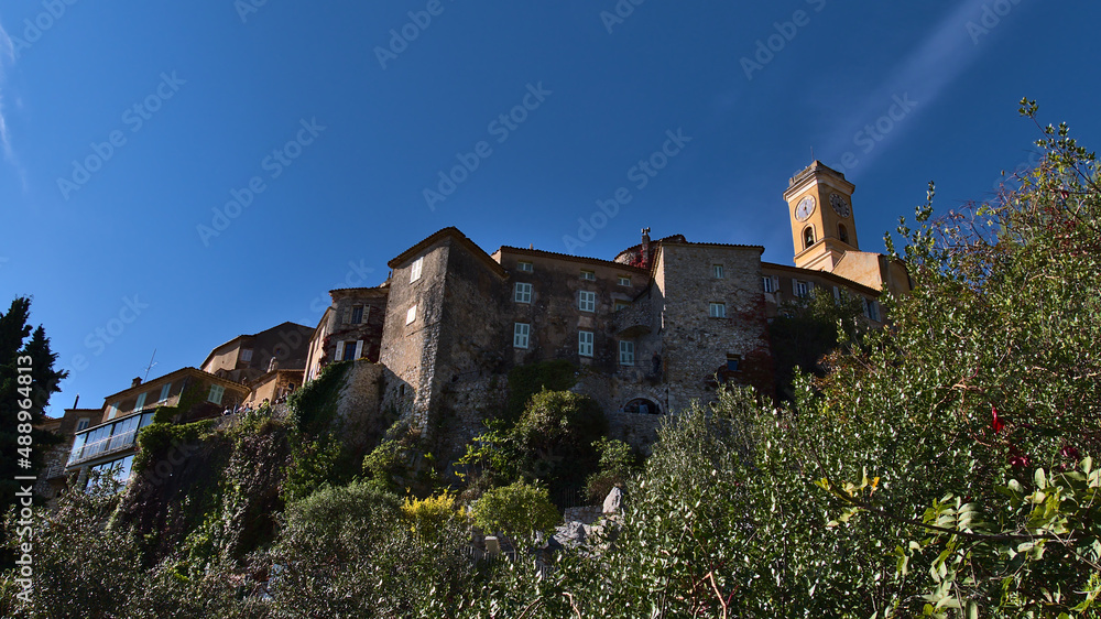 Low angle view of the historic center of small village Eze located on a rock at the French Riviera on a sunny day in autumn season with church.