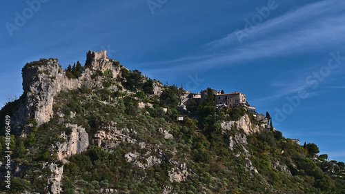 Beautiful view of historic village Eze located on a rock at the French Riviera on sunny day with old buildings and historic castle ruin. © Timon