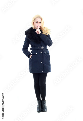 full length portrait of blonde woman wearing long winter coat. and casual clothes. standing pose, isolated on a white studio background. © faestock