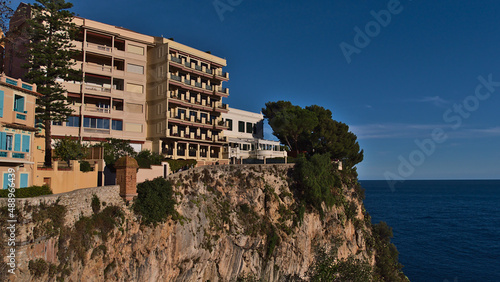 Beautiful view of the historic center of Monaco (Monaco-Ville) at the mediterranean coast with residential apartment buildings on a rocky cliff.