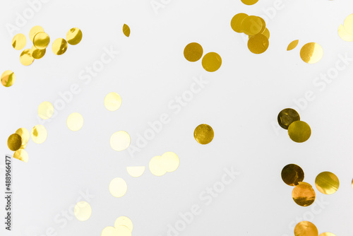 golden confetti on white background flat lay text place .