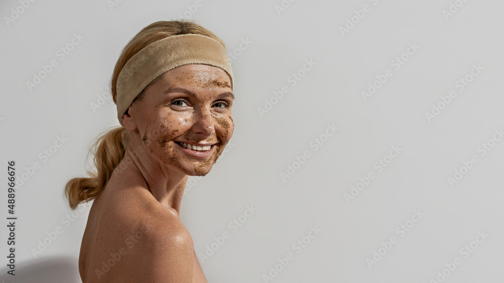 European woman with coffee and salt scrub on face European woman with coffee and salt scrub on face