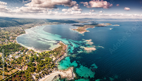Fototapeta Naklejka Na Ścianę i Meble -  Drone view of the sandy Karydi beach in the resort village of Vourvourou in Greece. Incredible patterns of different colors on calm sea water