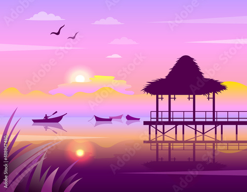 Tropical sunset on the coast with boats on the water and a pavilion above the water