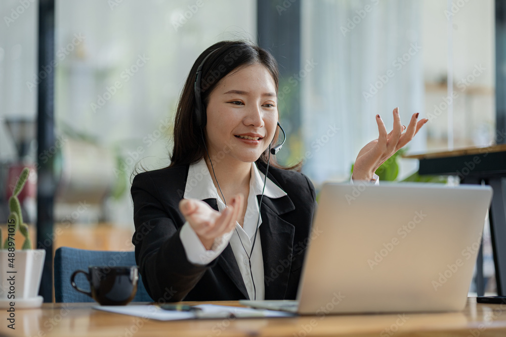 Beautiful Asian woman, she is a call center employee of an Internet and telephone company, she is responsible for providing service and assistance to customers through the phone. Call center concept. Beautiful Asian woman, she is a call center employee of an Internet and telephone company, she is responsible for providing service and assistance to customers through the phone. Call center concept.