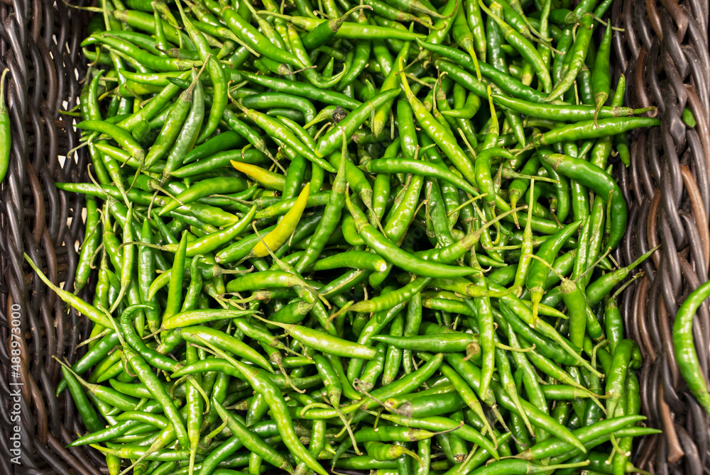 Green chili pepper on the counter of the store. Close-up. Green chili pepper on the counter of the store. Close-up.