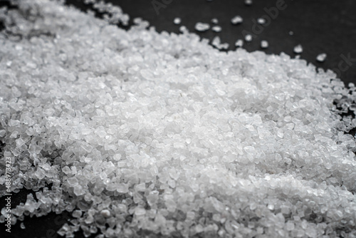 Bilde på lerret White coarse sea salt on a black background