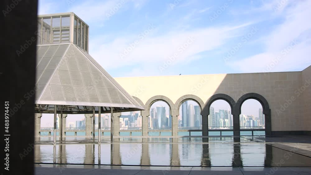 Exterior museum of islamic art doha qatar with skyline in background. Exterior museum of islamic art doha qatar with skyline in background.