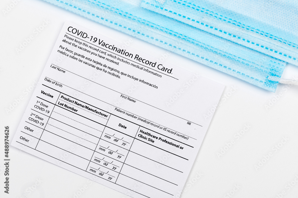 Coronavirus vaccination record card. Protective mask divided into two parts. Concept of defeating Covid-19 - Image Coronavirus vaccination record card. Protective mask divided into two parts. Concept of defeating Covid-19 - Image