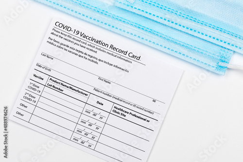 Wallpaper Mural Coronavirus vaccination record card. Protective mask divided into two parts. Concept of defeating Covid-19 - Image Torontodigital.ca