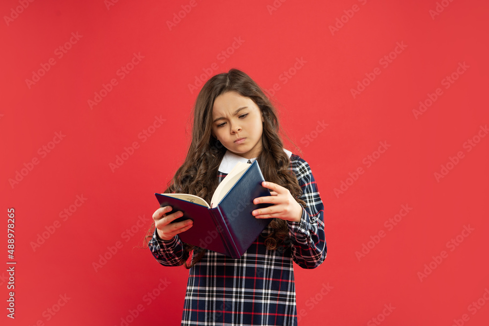 serious teen girl read book. child holding copybooks. concept of knowledge and wisdom. serious teen girl read book. child holding copybooks. concept of knowledge and wisdom.