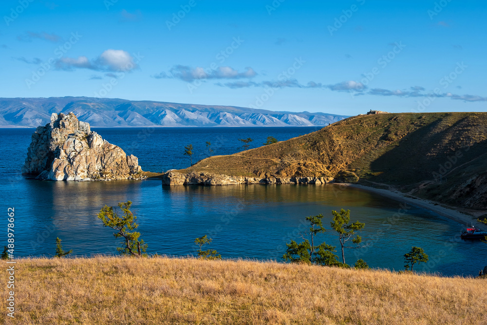 Shamanka Rock on lake Baikal near Khuzhir village at Olkhon island in September, Siberia, Russia. Lake Baikal is the deepest freshwater lake in the world.