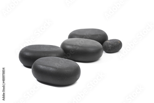 black spa stones isolated on white background .